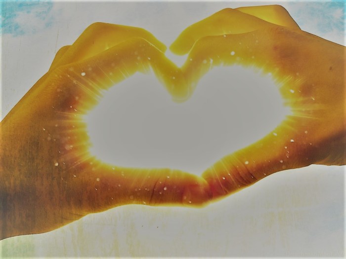 hands_making_love_heart_with_shining_light
